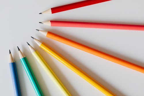Free Close-up of colorful sharpened pencils arranged on a white background. Stock Photo