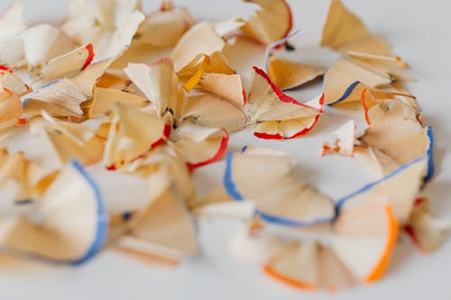 Free Color Pencil Shavings on a White Surface Stock Photo
