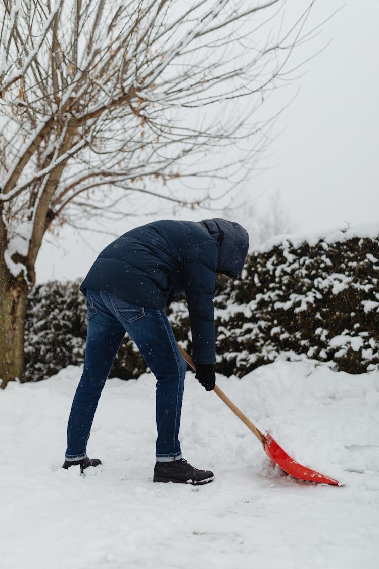 Man Shoveling Snow Outdoors