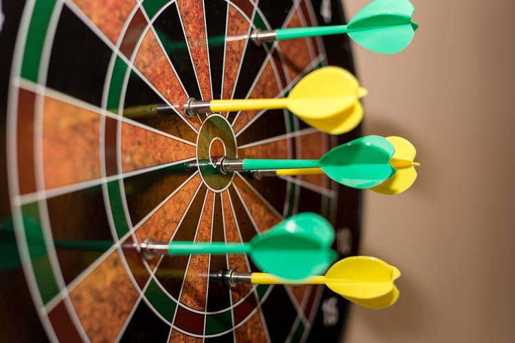 Green And Yellow Darts On Brown-black-green-and-red Dartboard