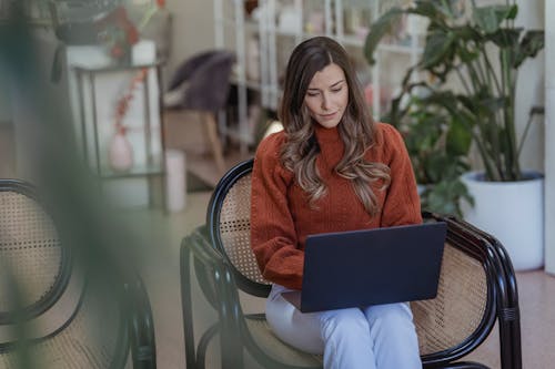 Free Serious female entrepreneur doing work on laptop Stock Photo