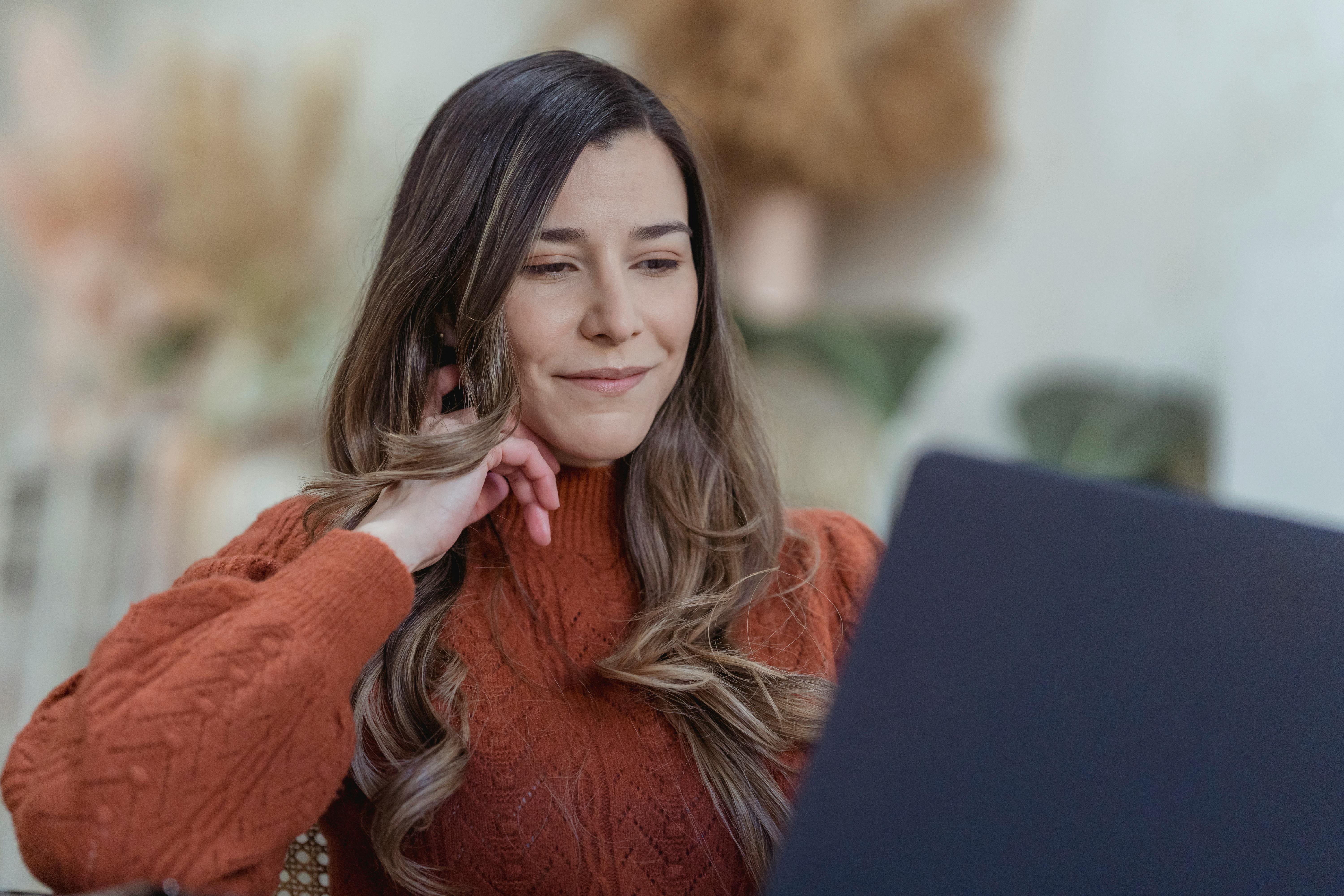 smiling woman browsing laptop for remote job