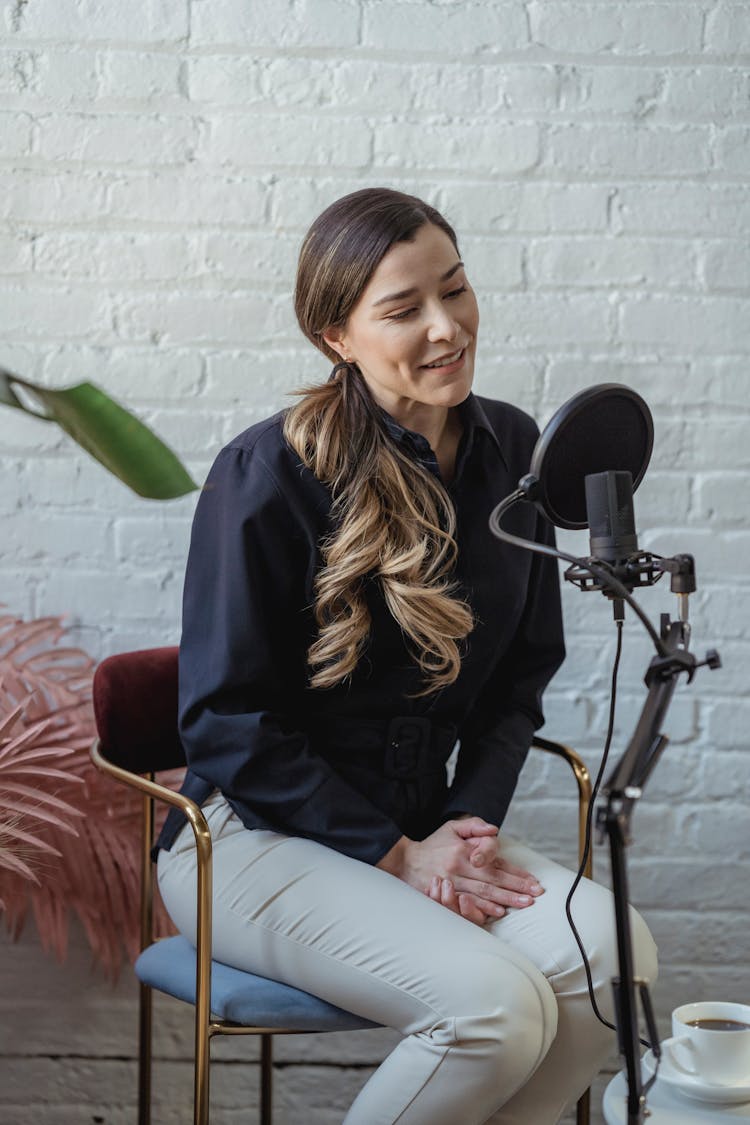 Woman In Casual Stylish Outfit Recording Voice With Microphone