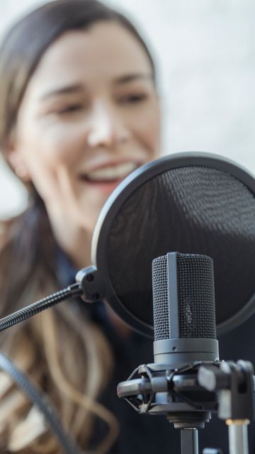 Host speaking into a microphone — photo by George Milton on Pexels