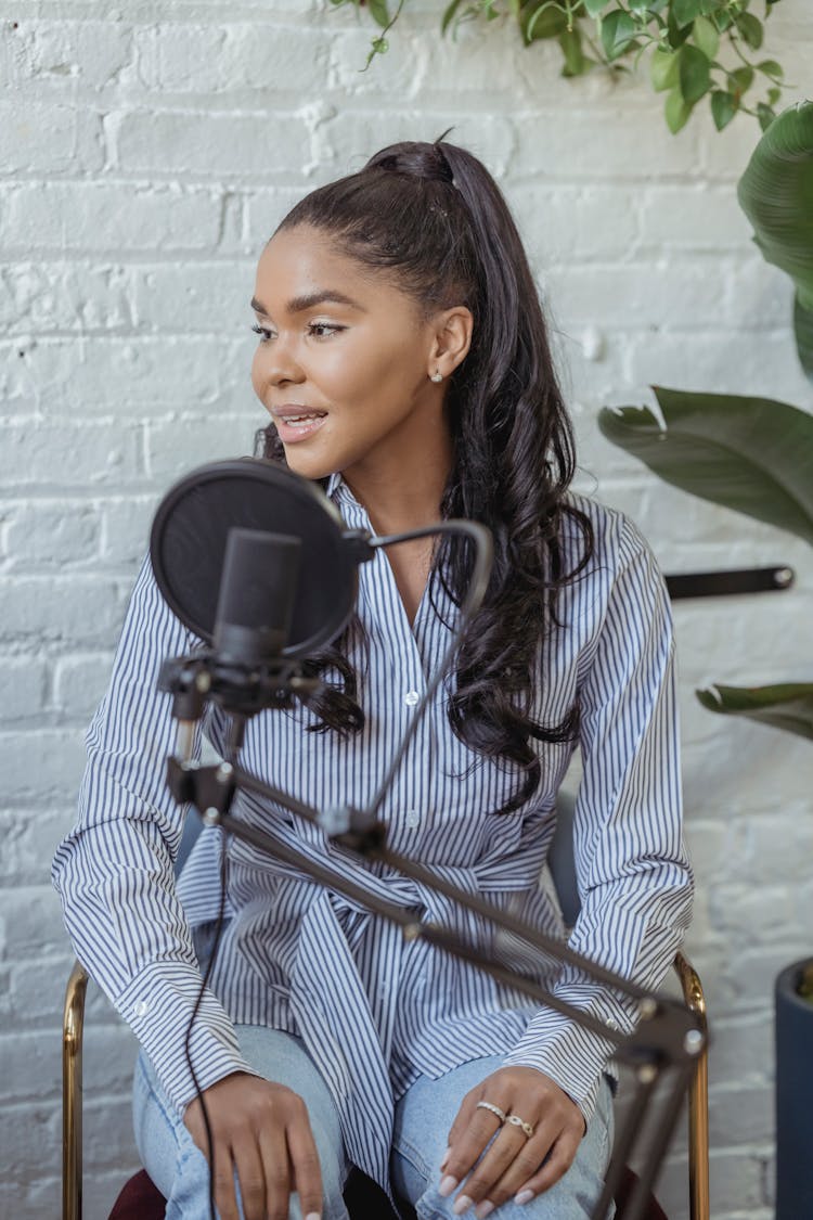 Black Woman In Trendy Outfit Near Microphone In Broadcasting Studio