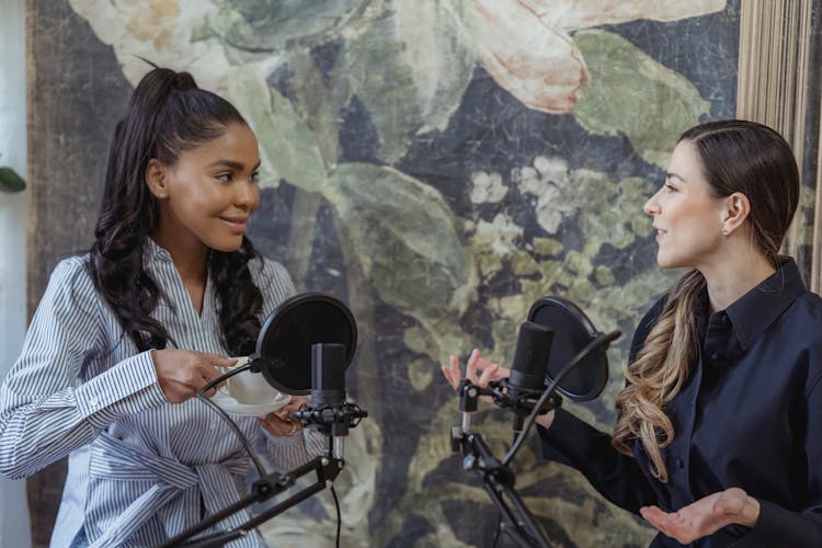 Women Having Conversation In Front Of The Condenser Microphone