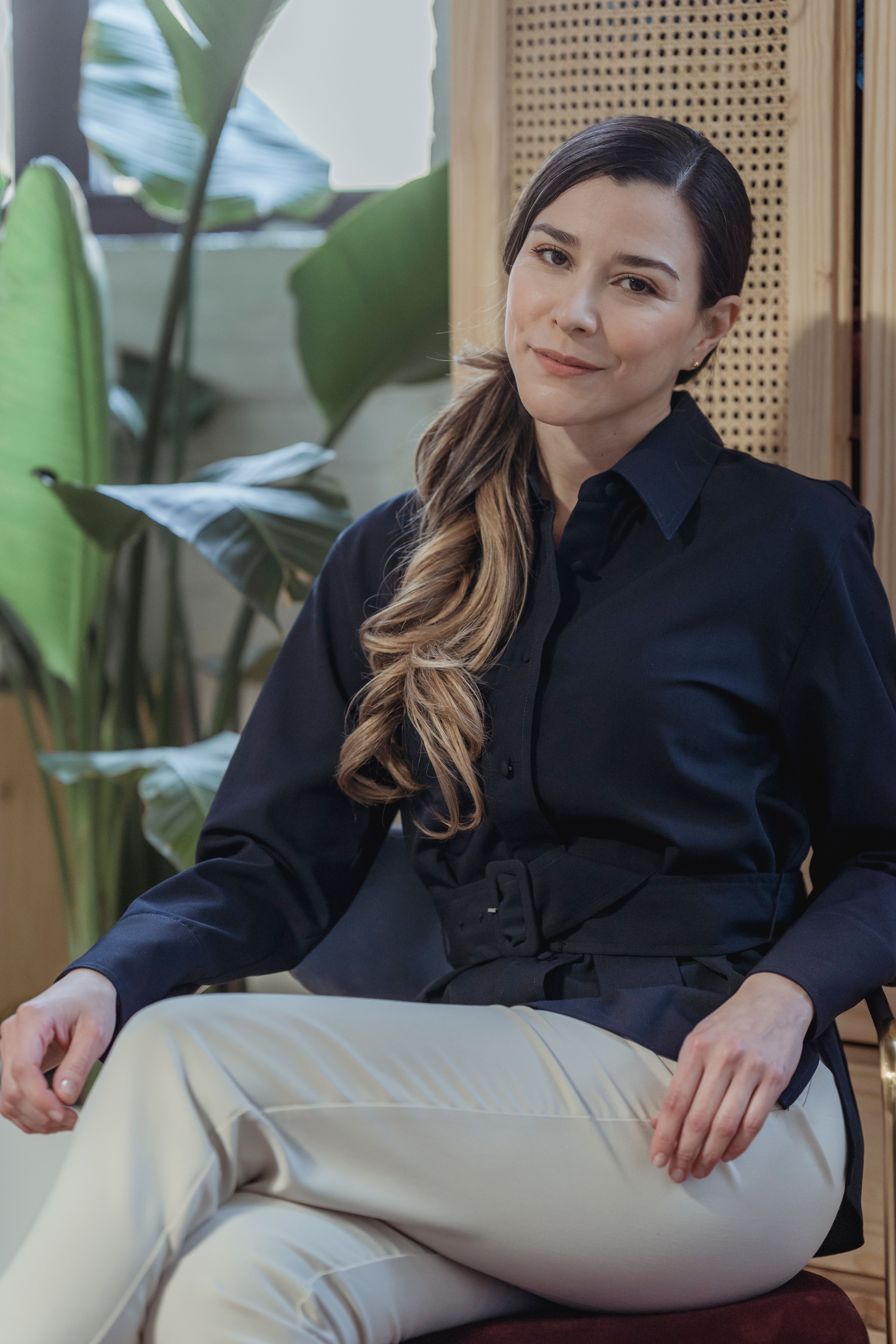 A Woman in Blue Long Sleeves Shirts Sitting on a Chair · Free Stock Photo