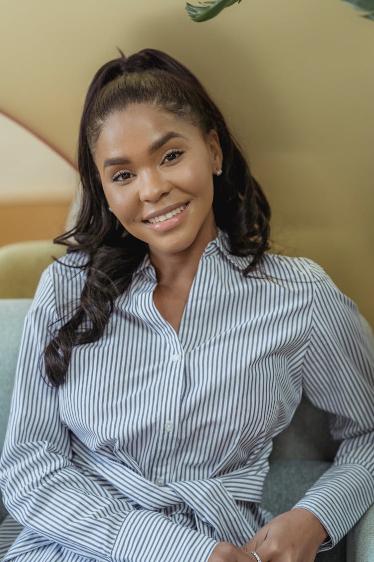 A Smiling Woman In Long Sleeves Striped Shirt