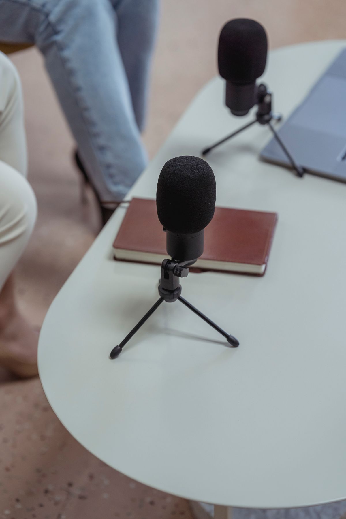 Microphones, notebook and laptops on a white table
