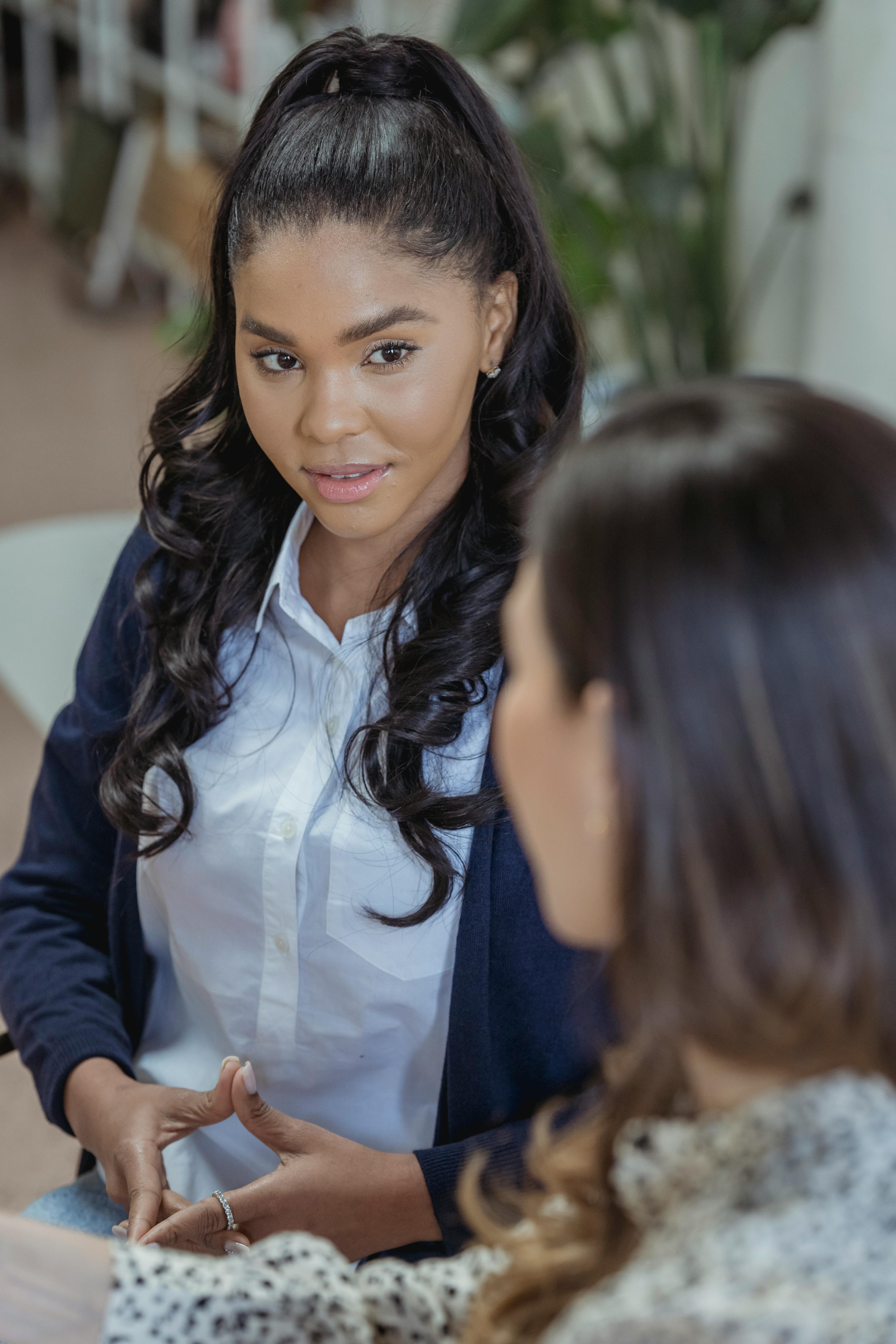 positive diverse women chatting in light room