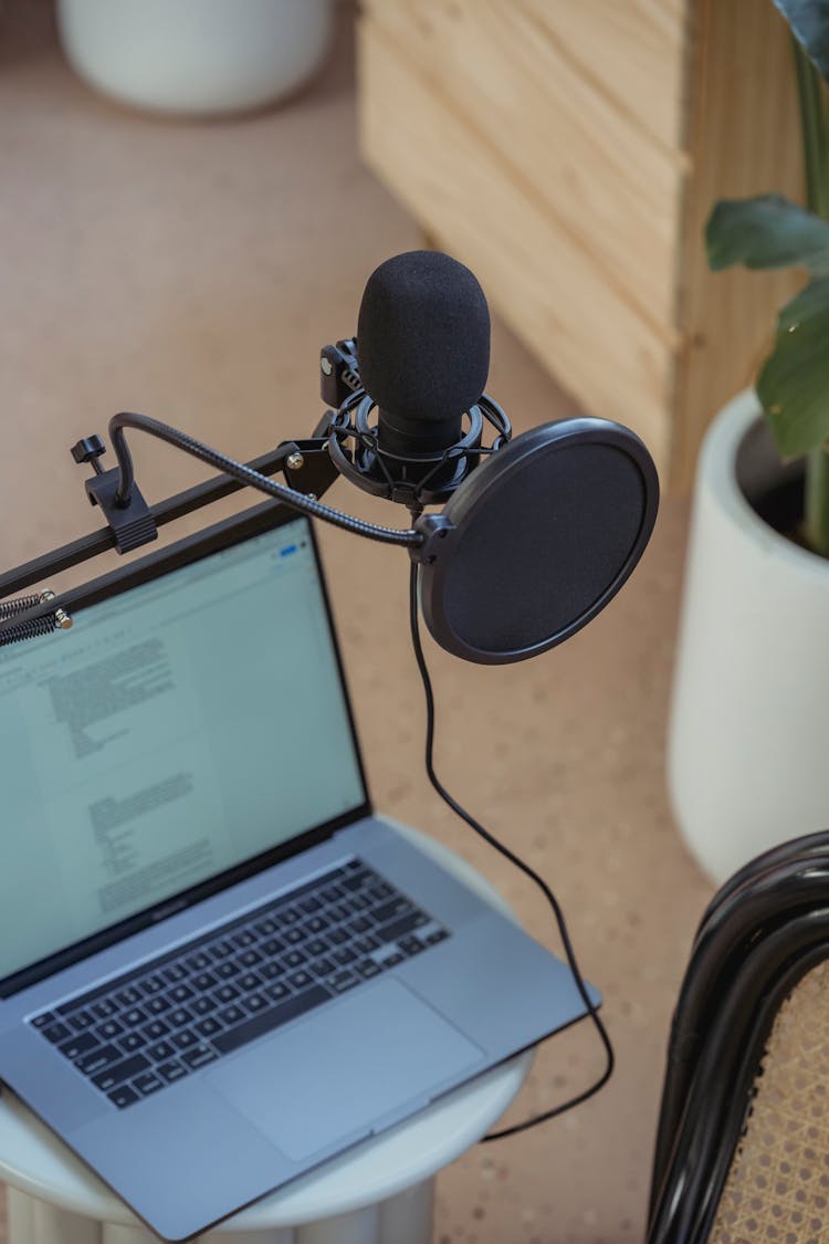 Microphone On Tripod Attached To Laptop In Studio