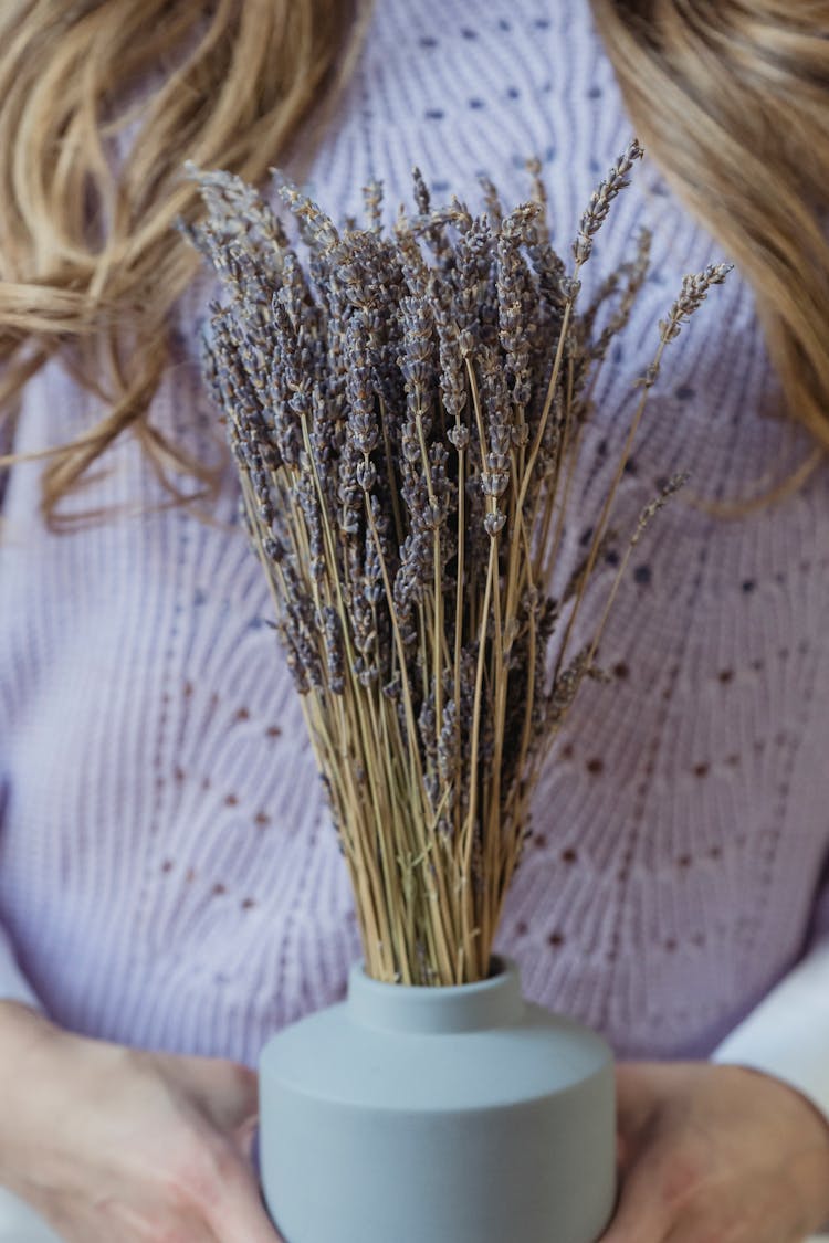 Woman With Bunch Of Lavender Flowers In Vase