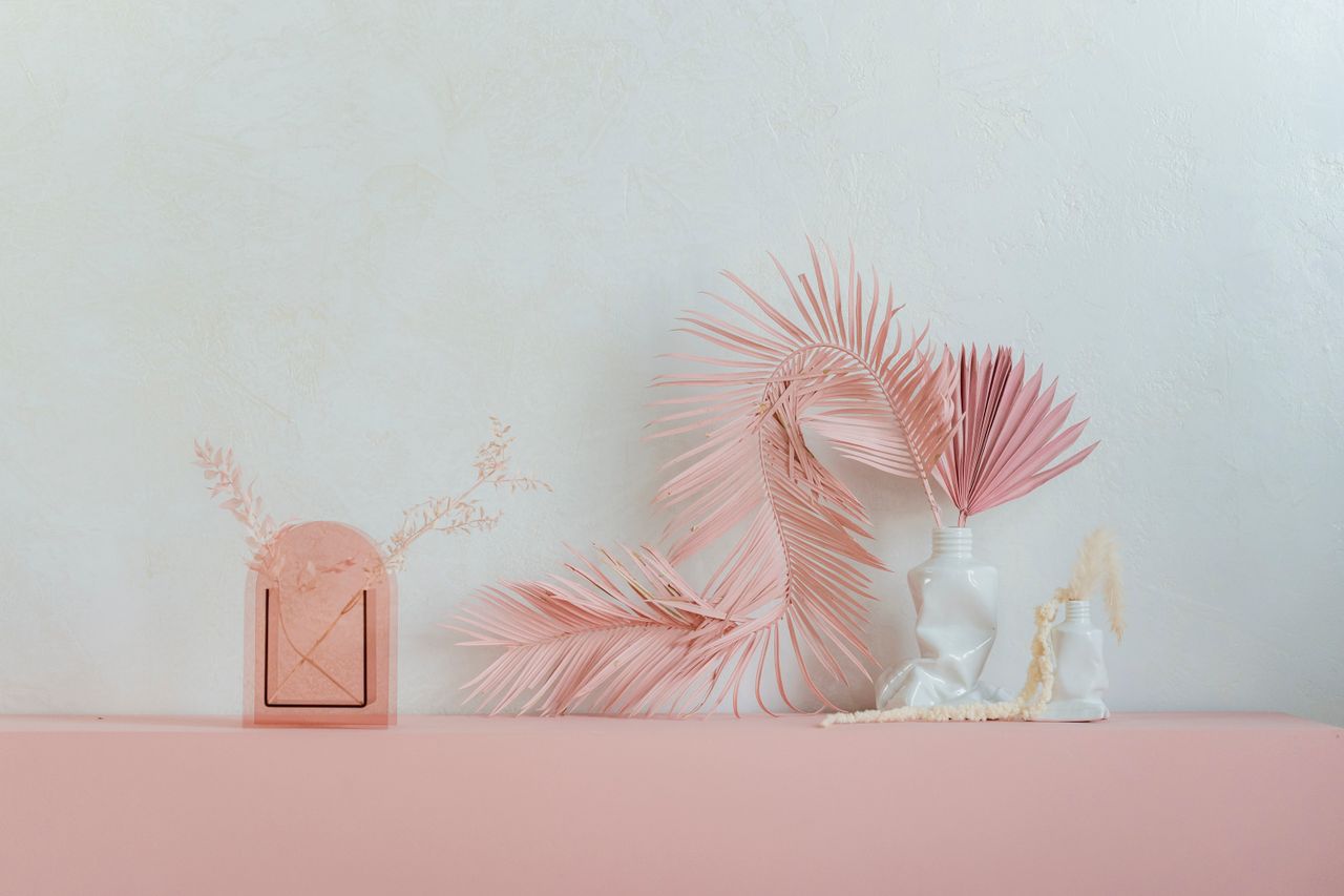 elegant composition of pink dried sun palm leaves placed in creative c