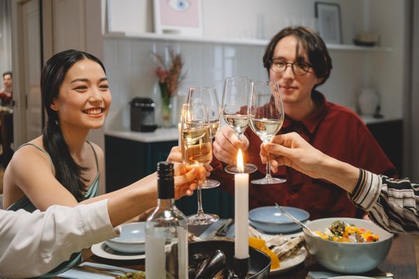 Friends toasting around a candlelit supper table. Photo by cottonbro studio on Pexels