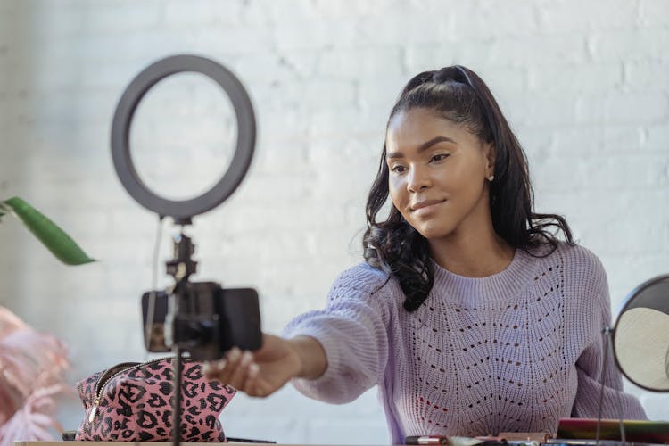 Happy Black Woman Preparing For Online Recording With Smartphone