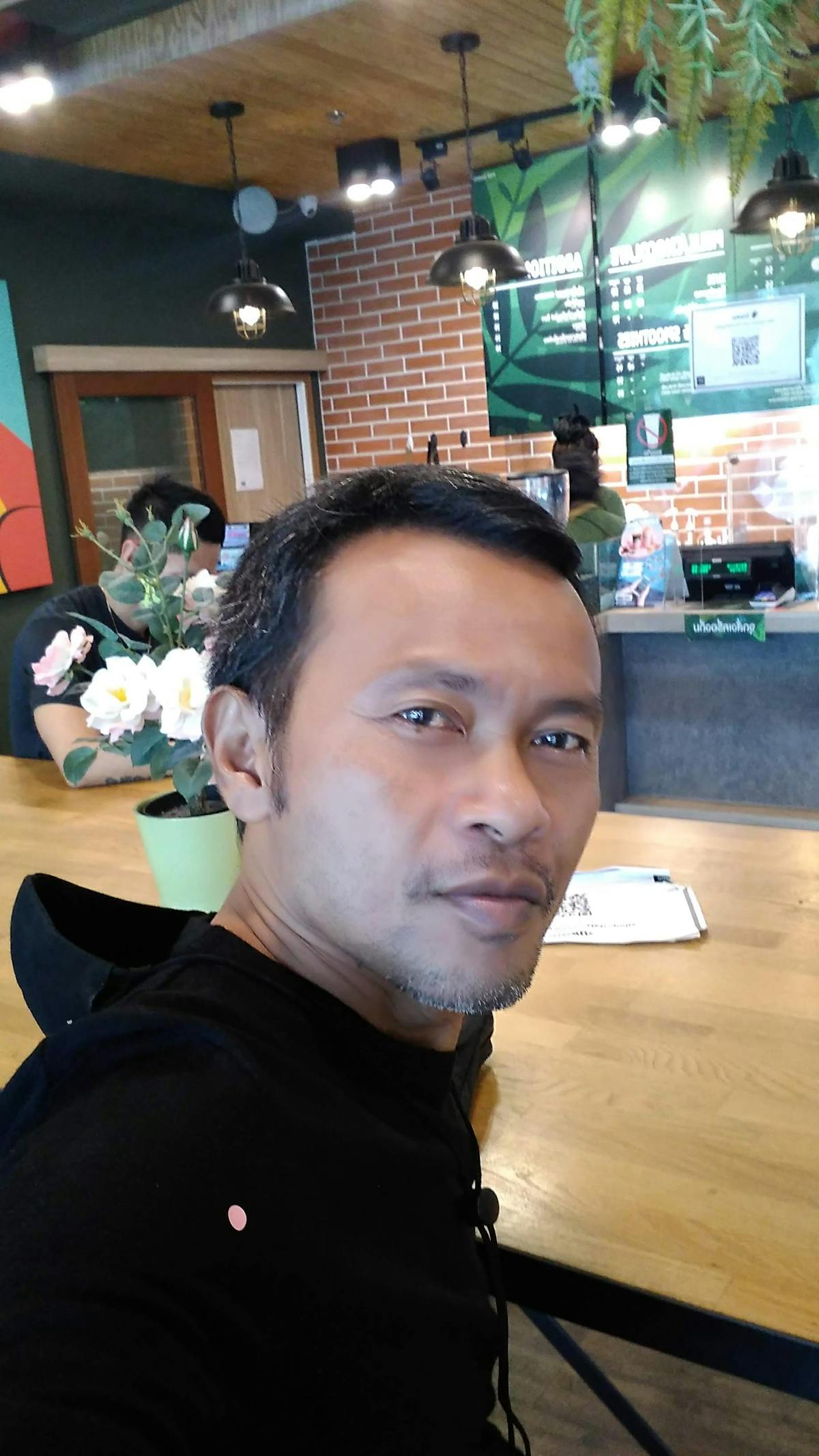 Person recording an educational video with a smartphone and notes on a desk