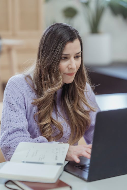Focused woman working on laptop