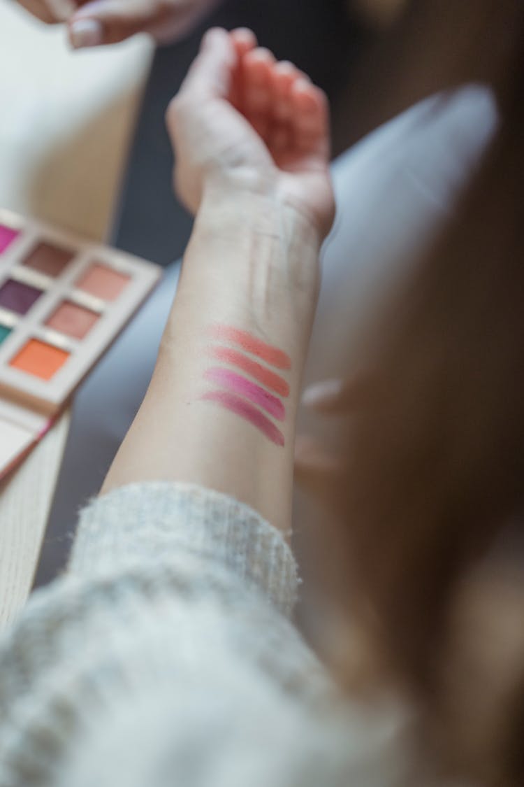 Crop Faceless Woman With Cosmetic Swatches On Arm Skin