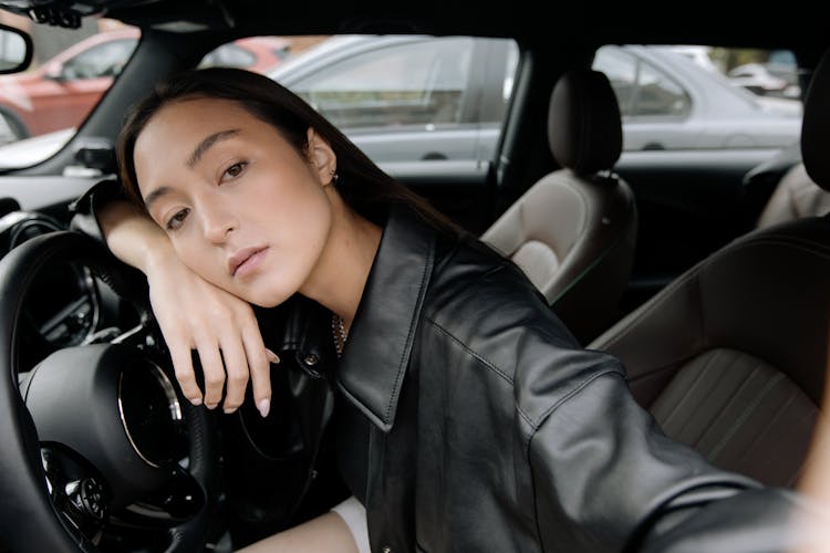 A Woman Sitting Inside A Car