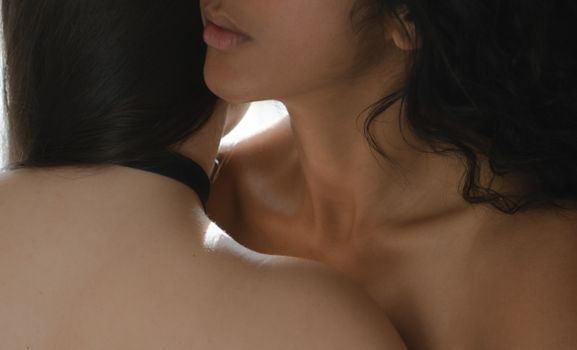 Close-up of two women in a tender embrace showcasing intimacy and connection.