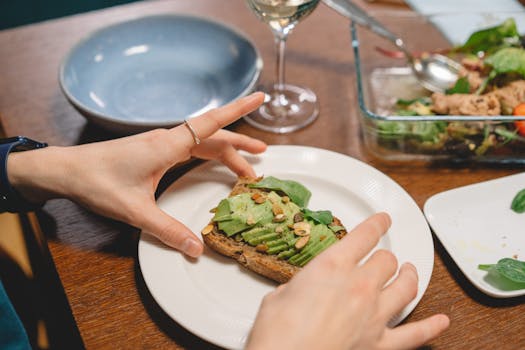 Close-up of avocado toast garnished with nuts on a plate, perfect for healthy meals.
