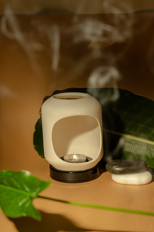 A Lighted Candle in a Ceramic Candle Holder
