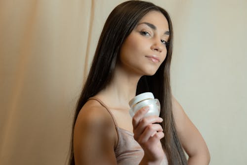 
A Woman Holding a Skin Care Product