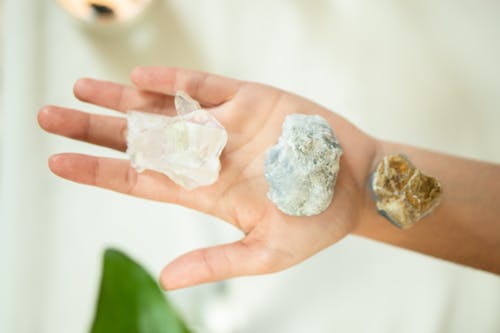 Overhead Shot of Crystal Stones on a Person's Hand
