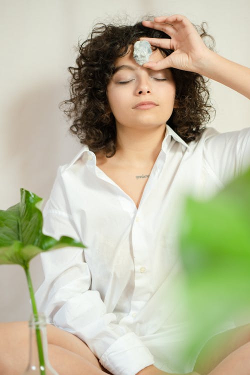 Photo of a Woman Holding a Crystal on Her Head