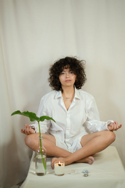 Photo of a Woman with Curly Hair Meditating