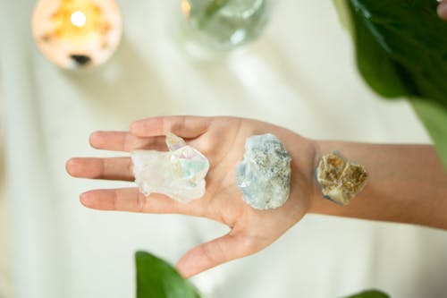 Close-Up Photo of Crystal Stones on a Person's Hand