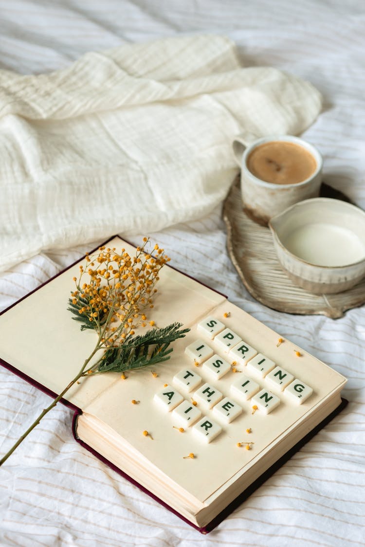 Cups Of Milk And Coffee Besides Scrabble Letter Tiles