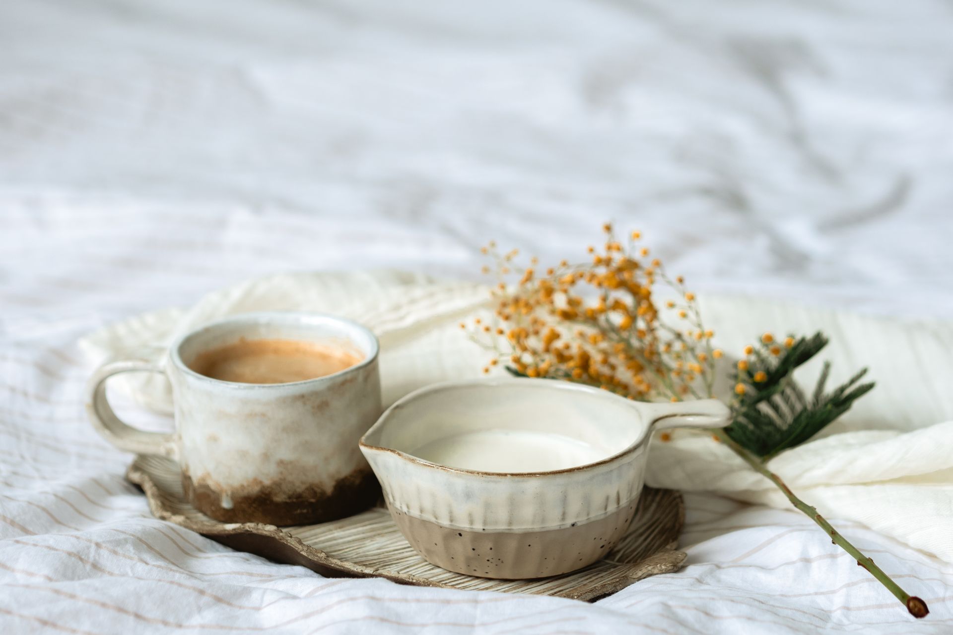 Cups of Milk and Coffee Beside a Spring Flower