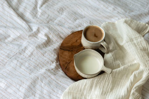 A serene arrangement of coffee and milk on a wooden tray, ideal for a cozy morning.