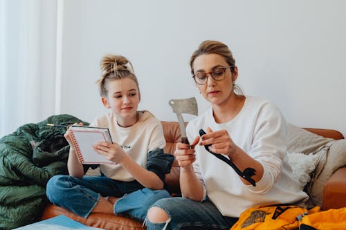 Free A Mother and Daughter Sitting on a Couch  Stock Photo