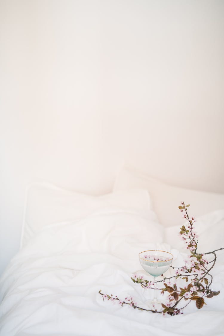 Photo Of A Bed With Flowers And A Cocktail Drink