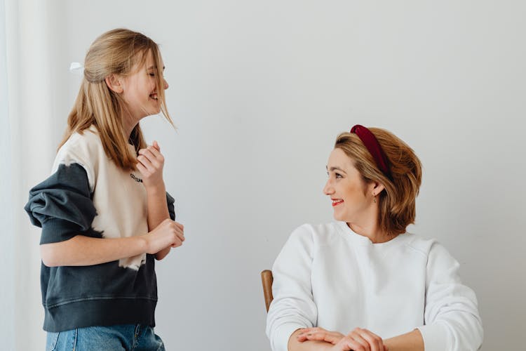 Smiling Mother And Daughter Talking