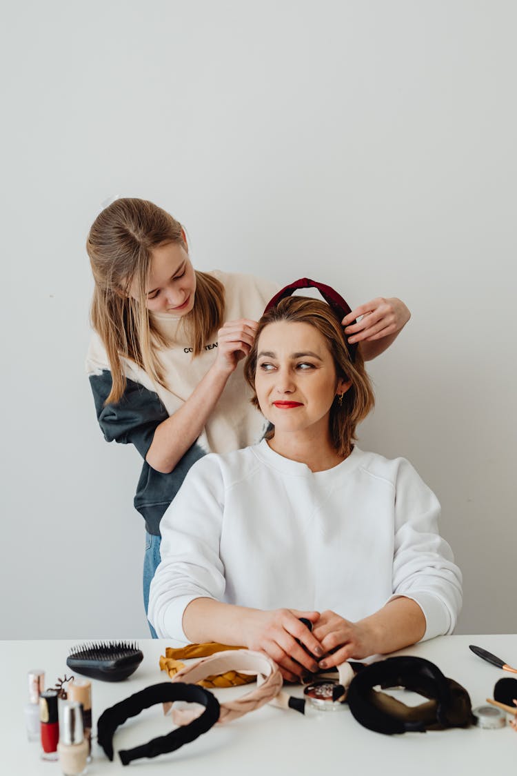 Daughter Putting A Headband On Her Mother
