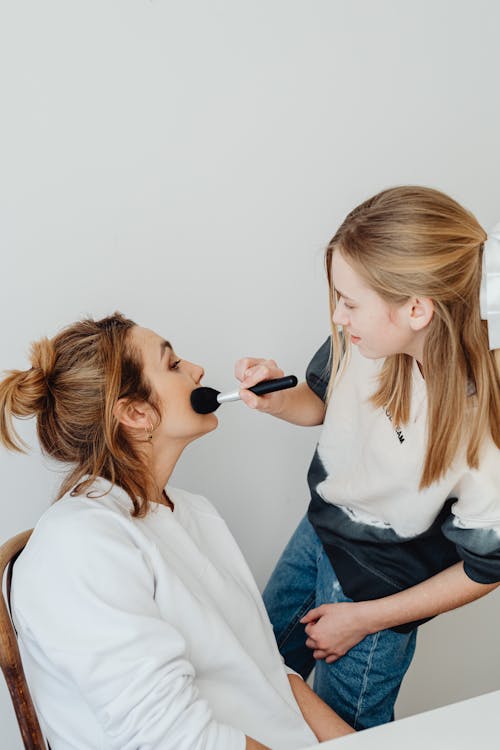 Daughter Applying Makeup on Her Mother