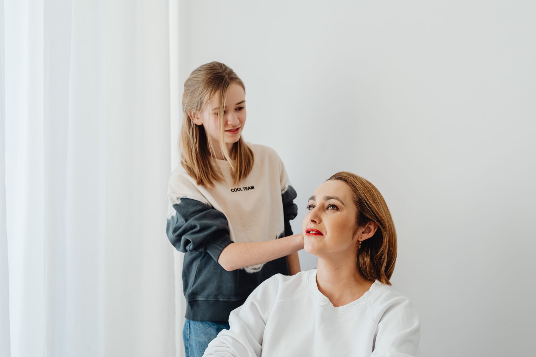Family beauty-care moment with a child in the background