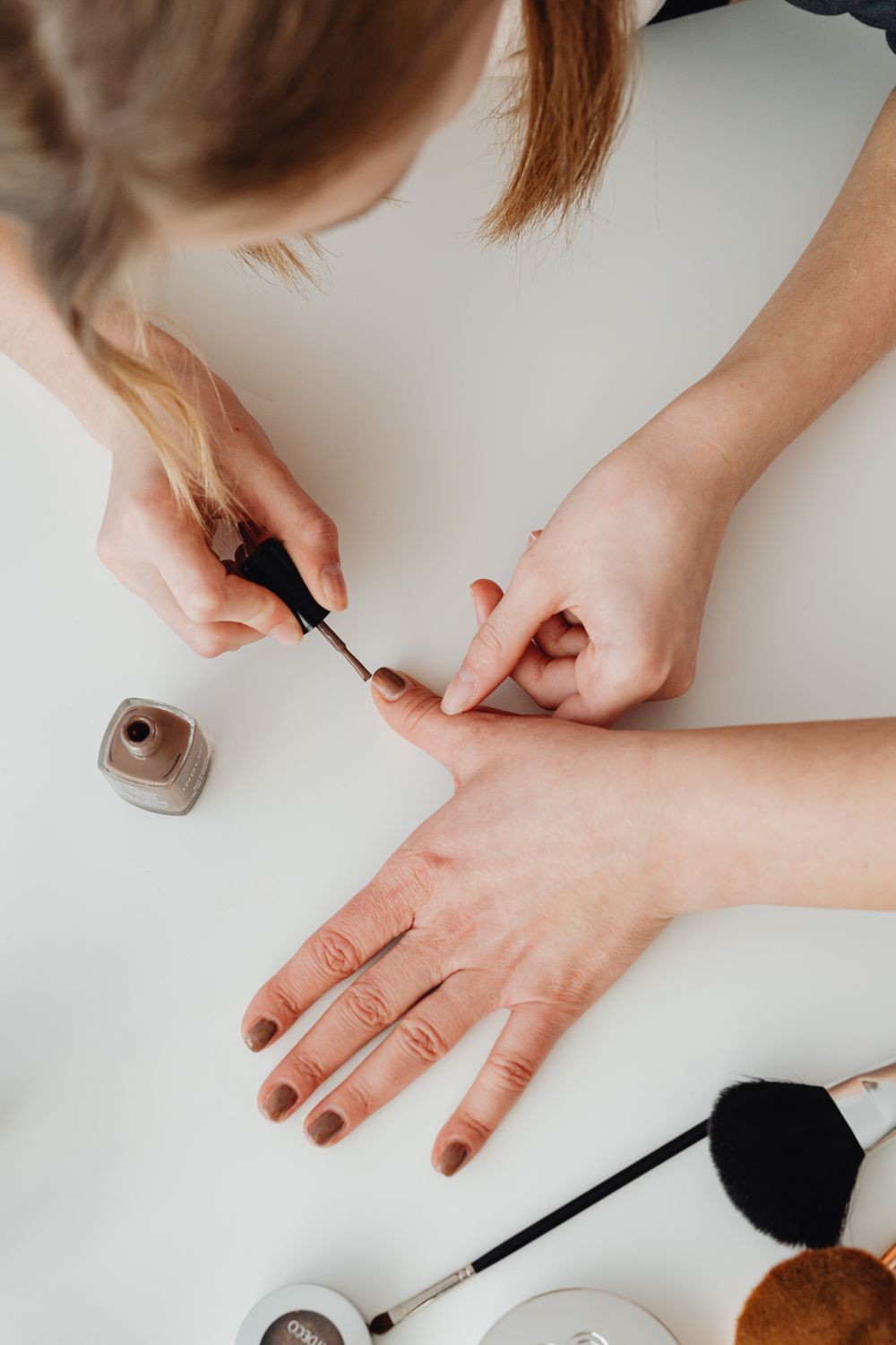 Colour being applied by hand at a work table