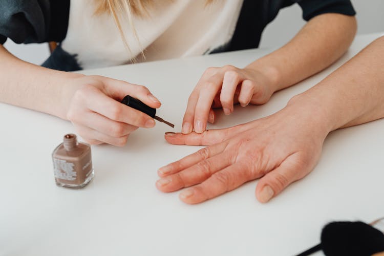 Doing Manicure With Nail Polish