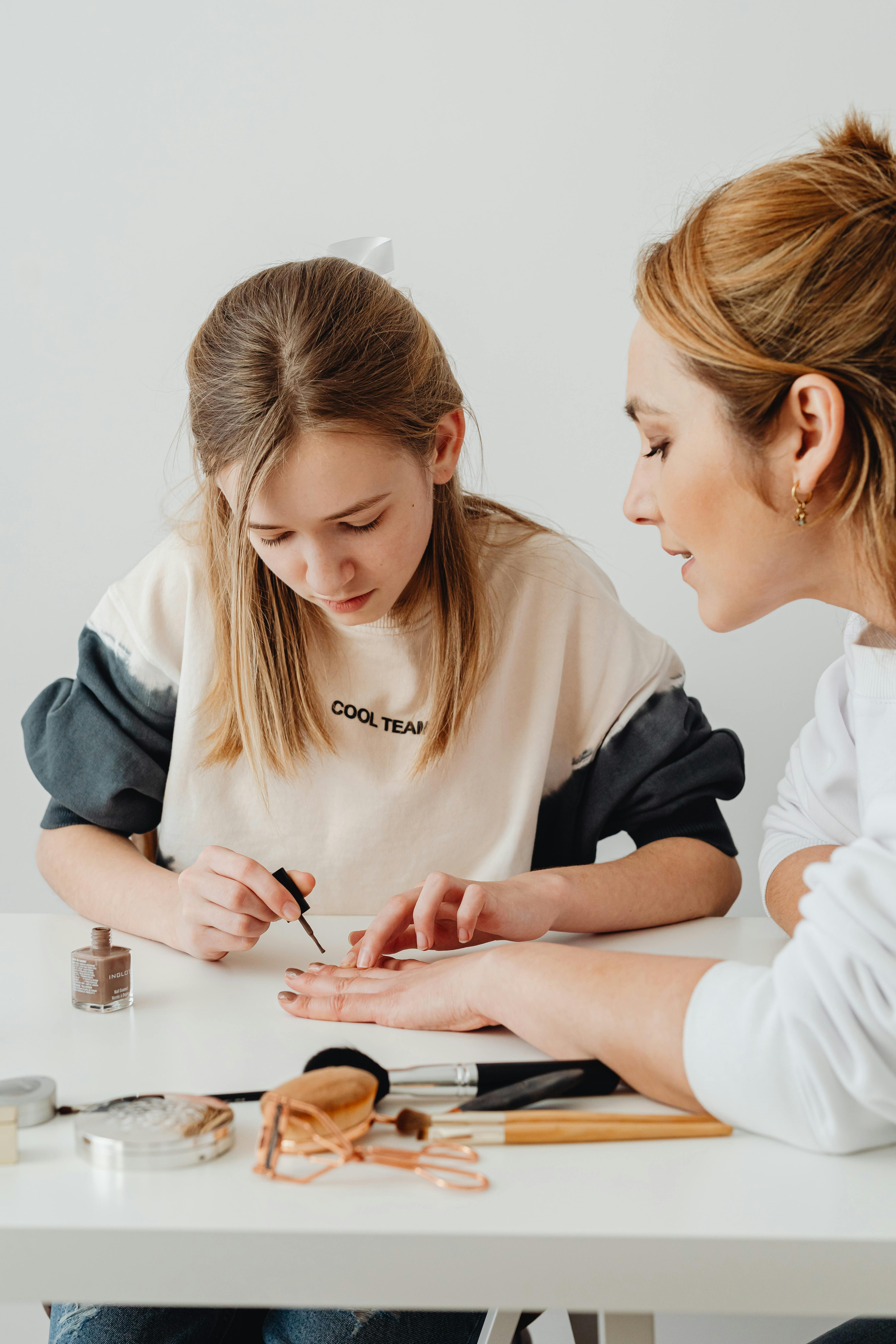 girl doing manicure for mother