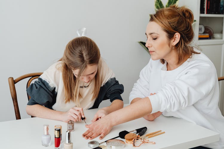 Girl Doing Manicure For Mother At Home