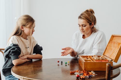 Free Woman in White Top Throwing Dices on the Table Stock Photo