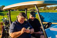 Man in Blue Polo Shirt Beside Man in Black Crew Neck T-shirt