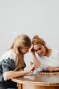 Women Looking at the Sticks on the Table