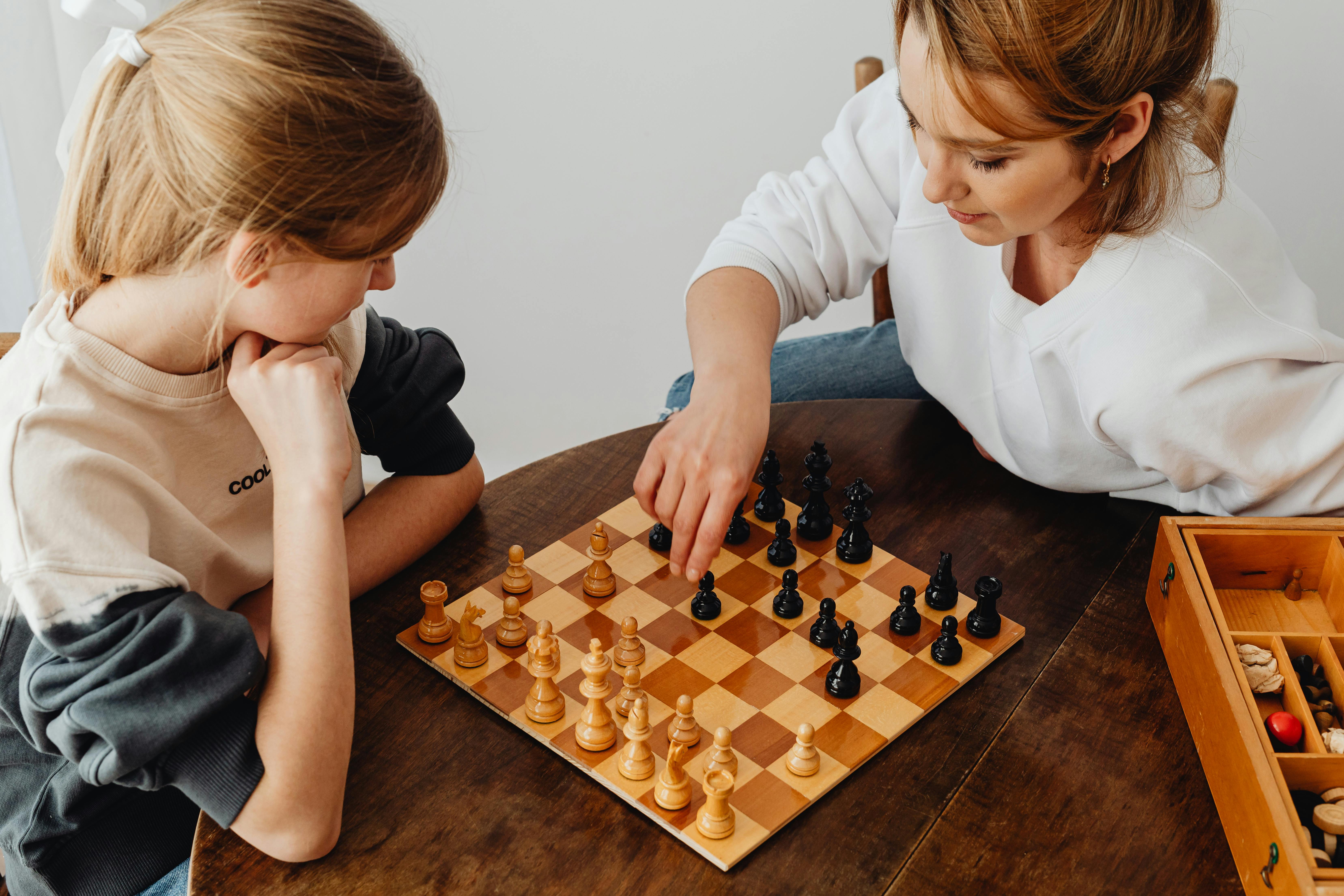 Daughter Picking Best Chess Moves For Parents While Playing Chess In  Mountain Cottage Stock Photo - Download Image Now - iStock