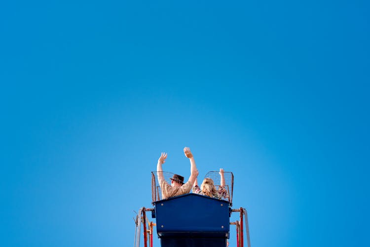 Couple Riding A Ferris Wheel Together