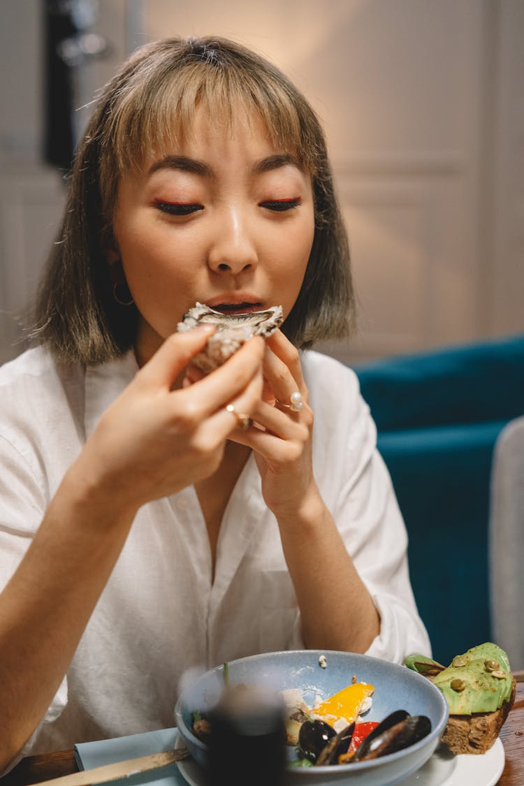 Woman Eating An Oyster